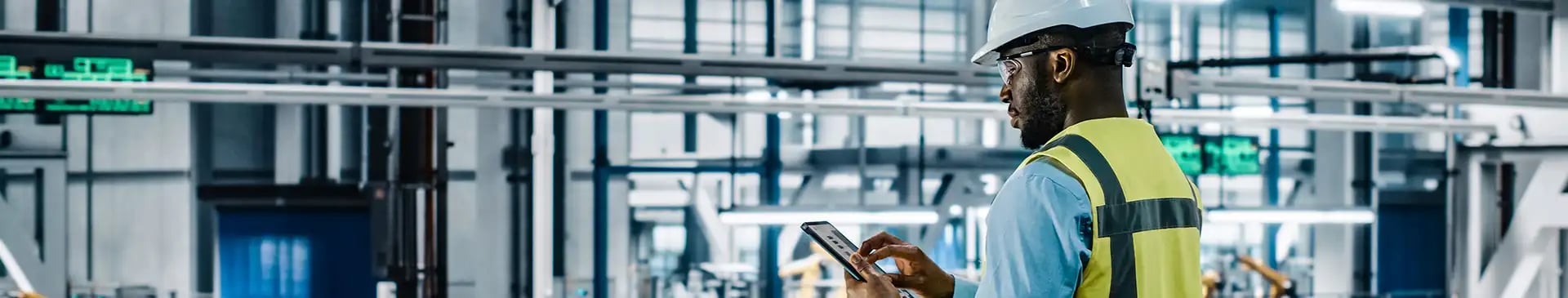 Man standing with tablet in production